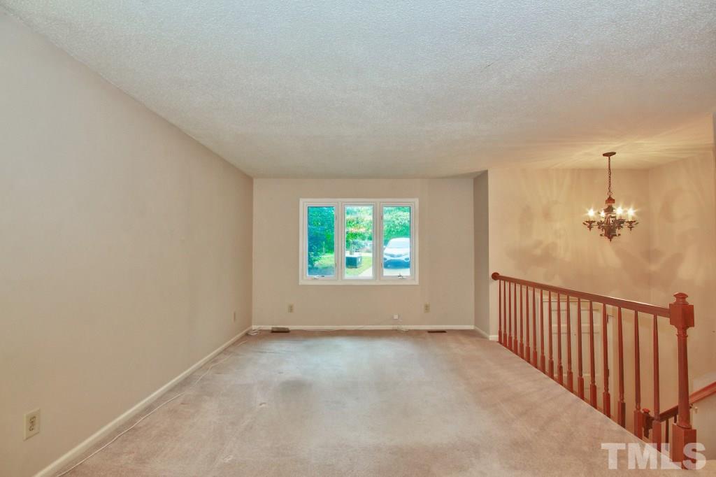 7609 Rambeau Circle Raleigh, NC 27613 - Photo 4 of 22 an empty room with windows