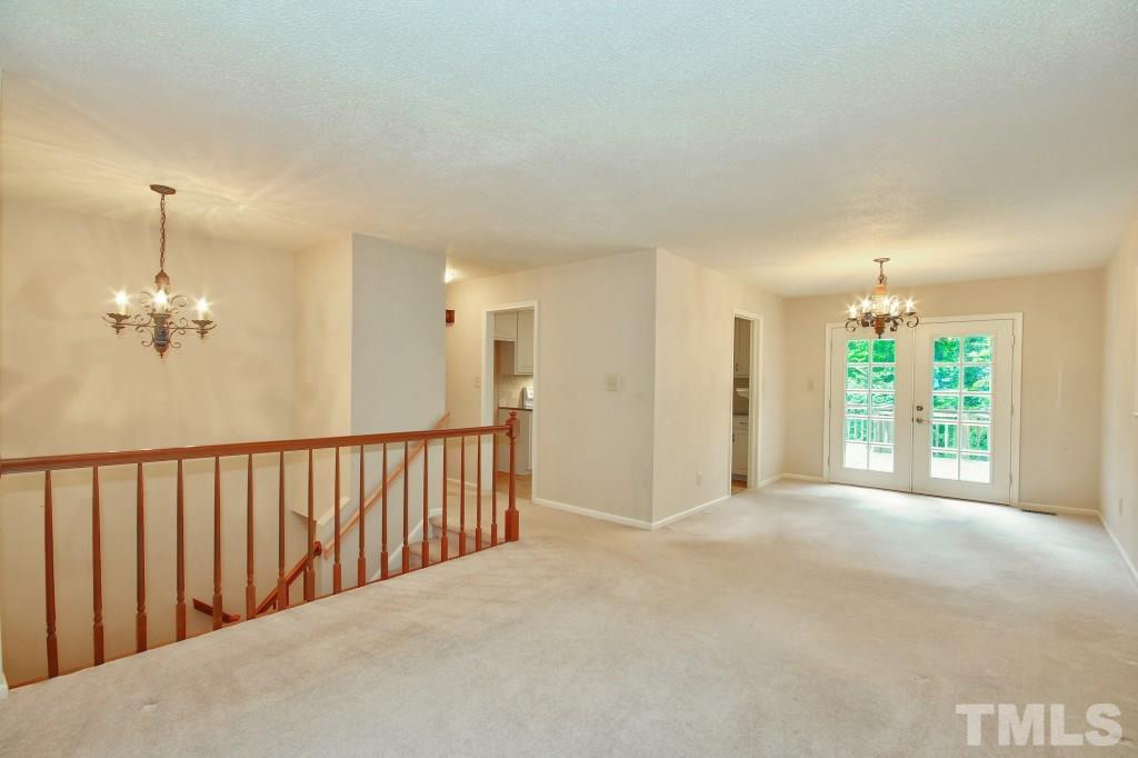 7609 Rambeau Circle Raleigh, NC 27613 - Photo 5 of 22 a view of a hallway with an empty room and chandelier fan