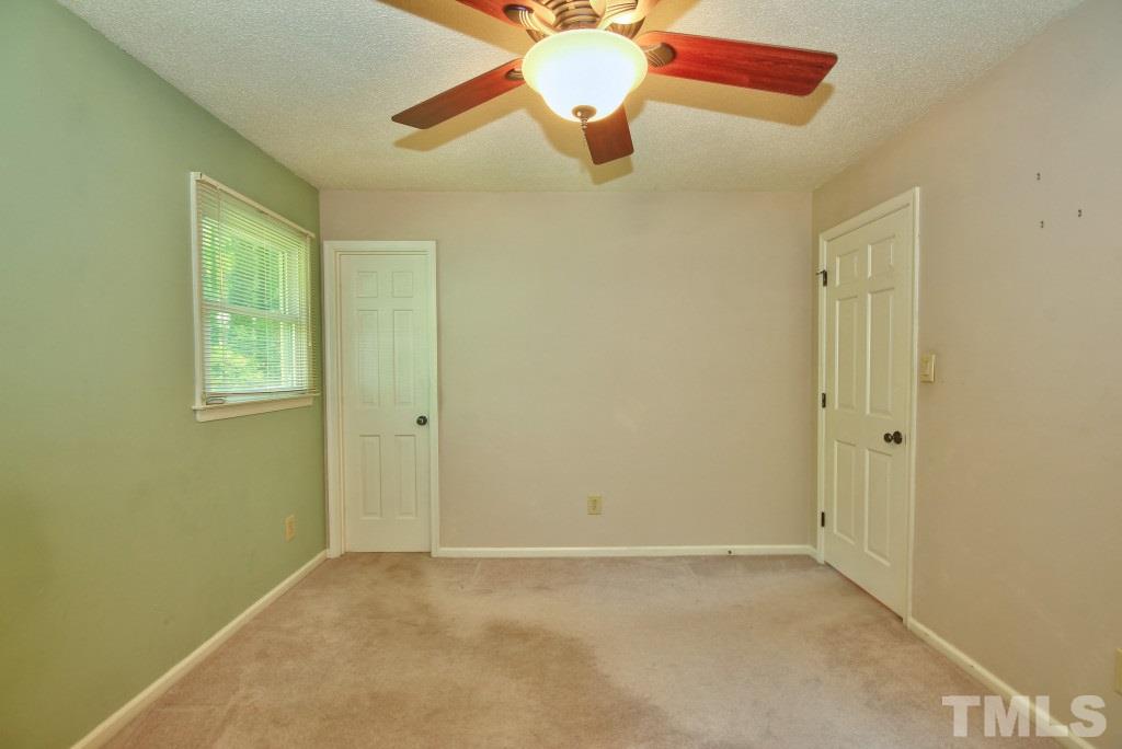 7609 Rambeau Circle Raleigh, NC 27613 - Photo 10 of 22 an empty room with closet and a chandelier fan