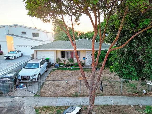 a front view of house with deck and yard
