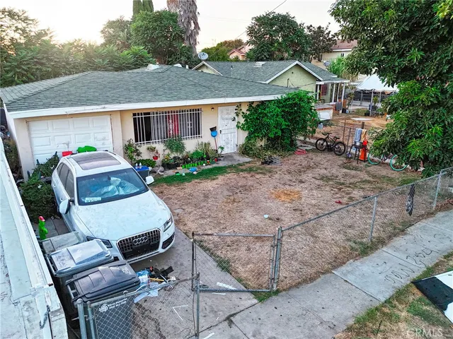 a view of a car park in front of a house