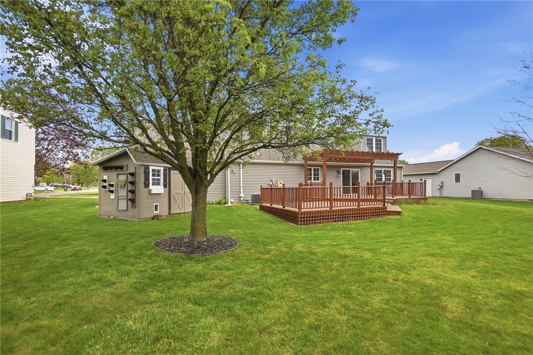 135 Concord Farm Road Englewood, OH 45322 - Photo 43 of 46 This spacious backyard features a large deck with pergola, perfect for outdoor living and entertaining.