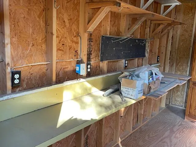 a view of a small house with wooden fence