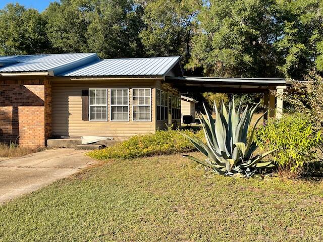 3107 Mayhair Road Crestview, FL 32539 - Photo 4 of 33 front view of a house with a large window and potted plants