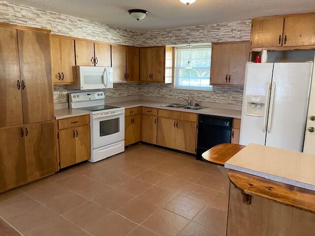 3107 Mayhair Road Crestview, FL 32539 - Photo 9 of 33 a kitchen with stainless steel appliances granite countertop a refrigerator a sink dishwasher a stove with wooden cabinets and floor