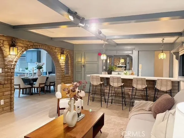 a living room with lots of furniture and a large mirror