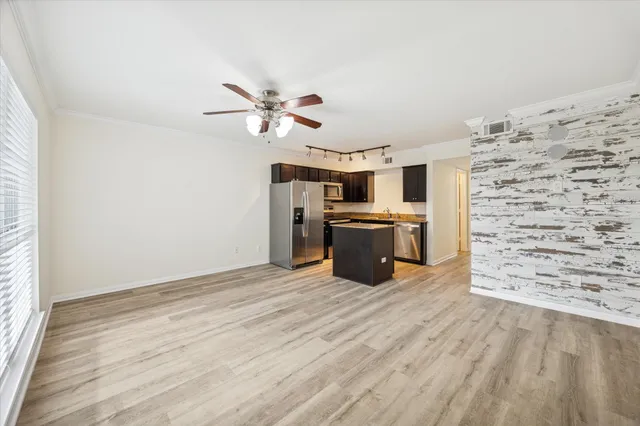 a view of kitchen with sink microwave and refrigerator