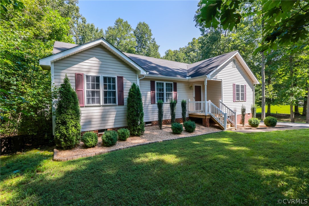 a front view of a house with a yard and trees