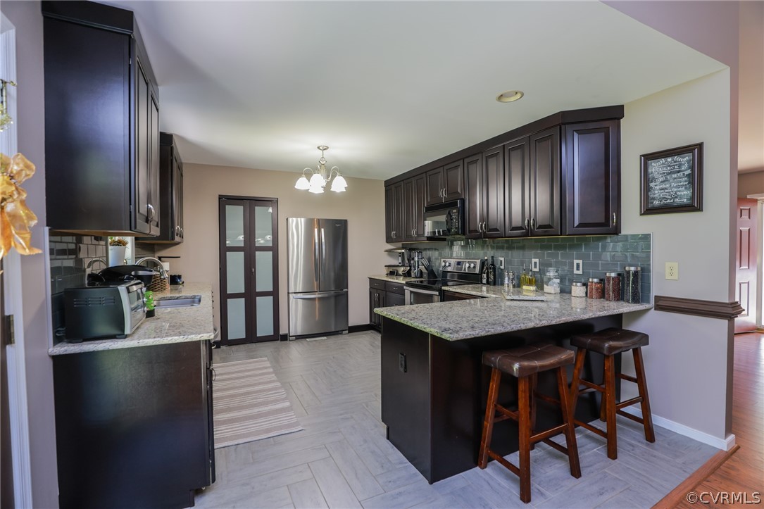11706 Corte Castle Road Chesterfield, VA 23838 - Photo 14 of 44 a kitchen with stainless steel appliances granite countertop a sink refrigerator and cabinets