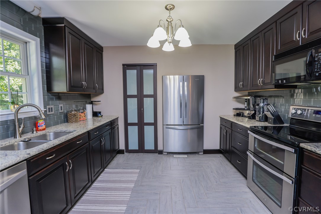 11706 Corte Castle Road Chesterfield, VA 23838 - Photo 15 of 44 a kitchen with stainless steel appliances granite countertop a refrigerator a sink dishwasher a stove top oven a refrigerator with wooden cabinets and floor