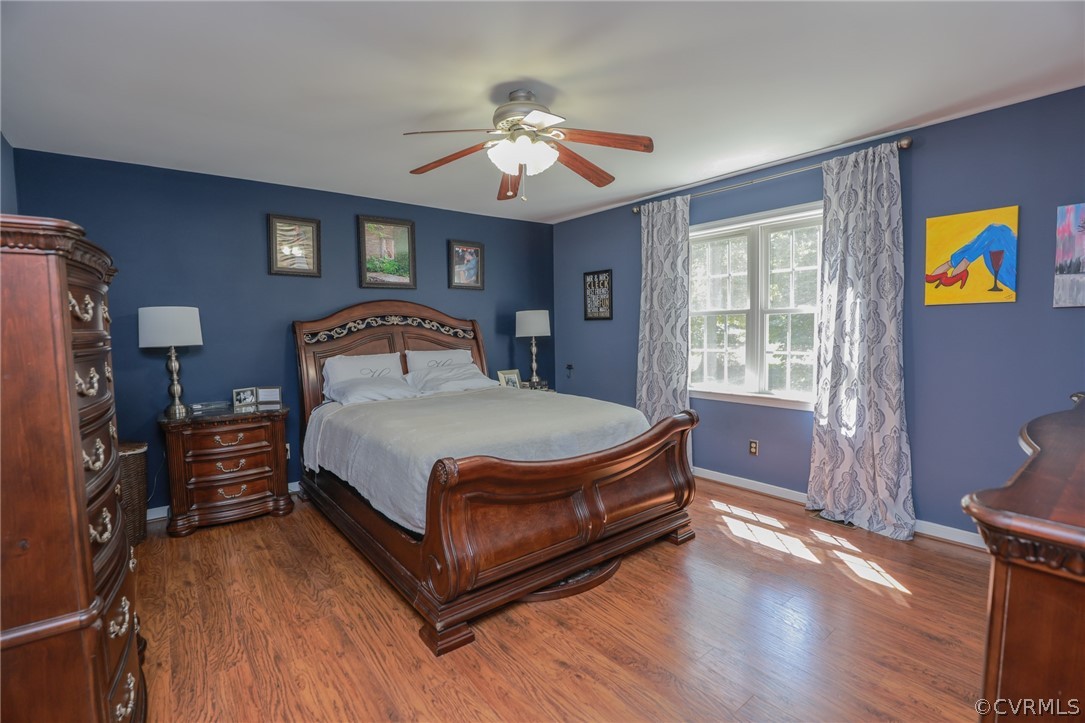 11706 Corte Castle Road Chesterfield, VA 23838 - Photo 22 of 44 a bedroom with a bed and wooden floor