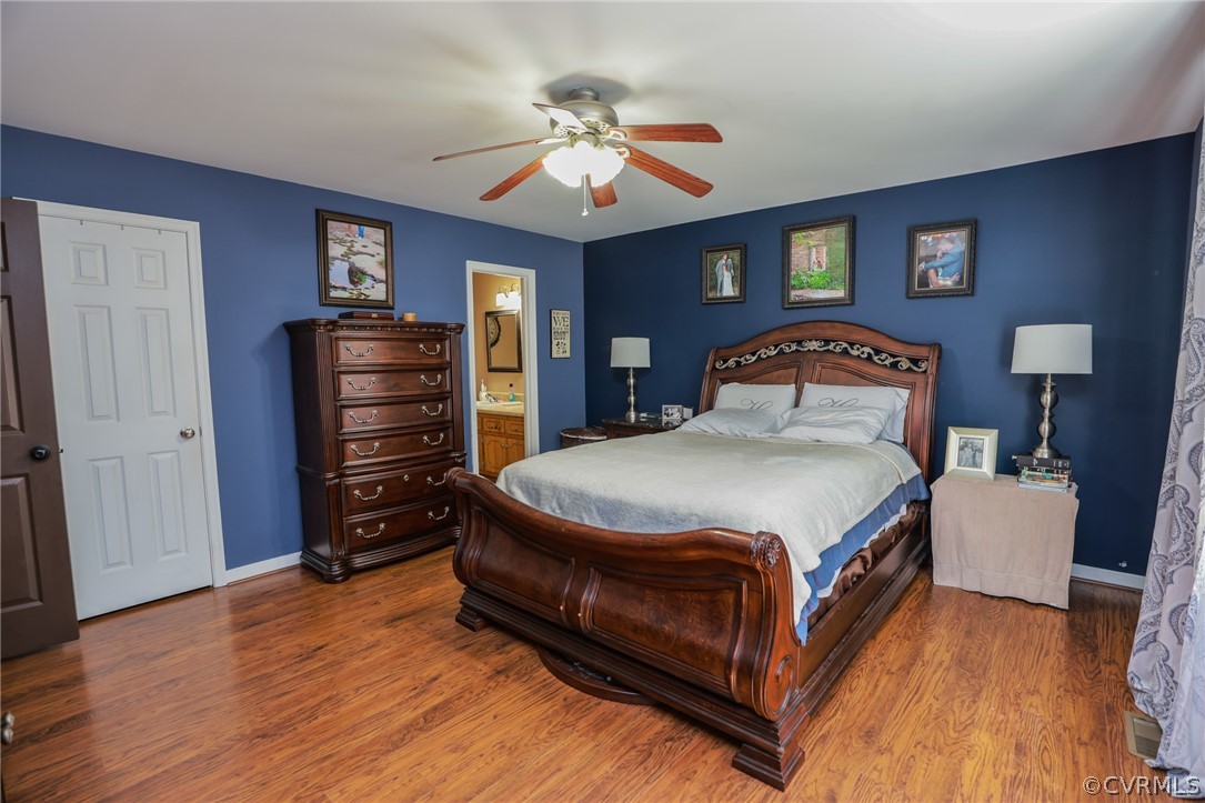 11706 Corte Castle Road Chesterfield, VA 23838 - Photo 23 of 44 a bedroom with a bed and a chandelier