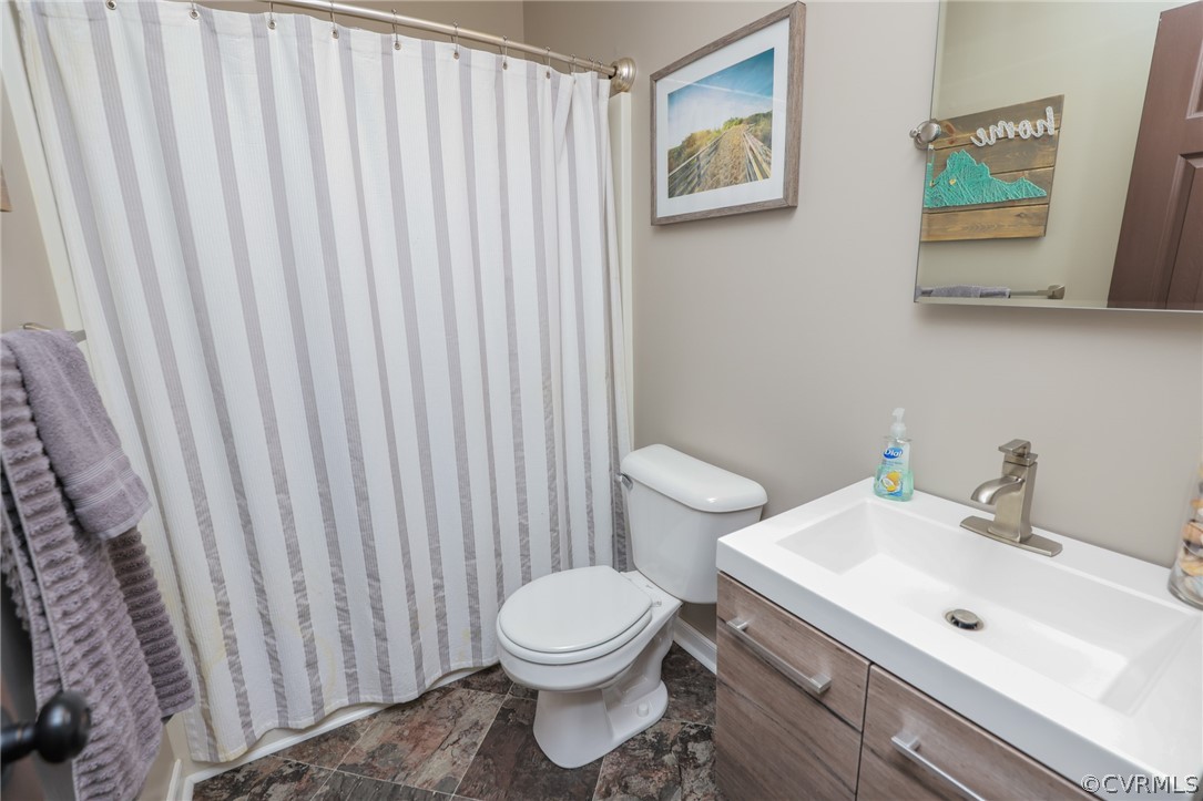 11706 Corte Castle Road Chesterfield, VA 23838 - Photo 29 of 44 a bathroom with a toilet a sink and a shower curtain