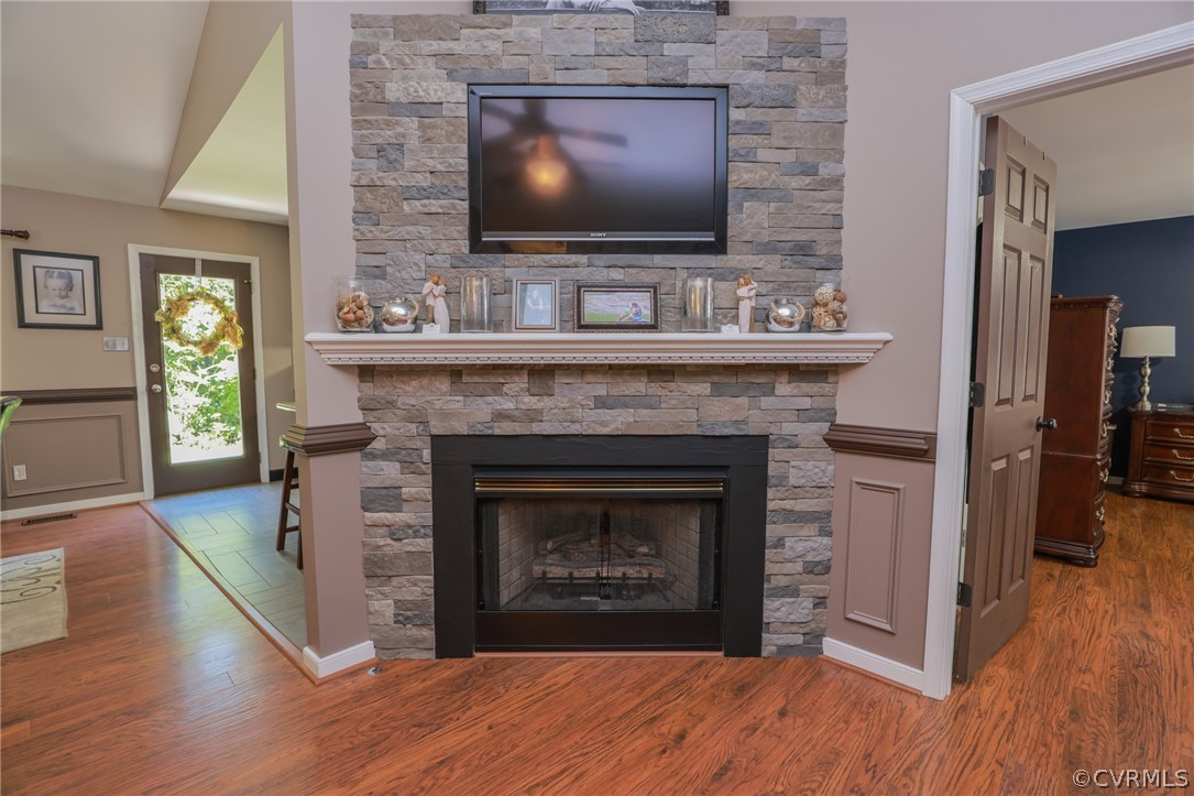 11706 Corte Castle Road Chesterfield, VA 23838 - Photo 9 of 44 a living room with a fireplace a flat screen tv and wooden floor