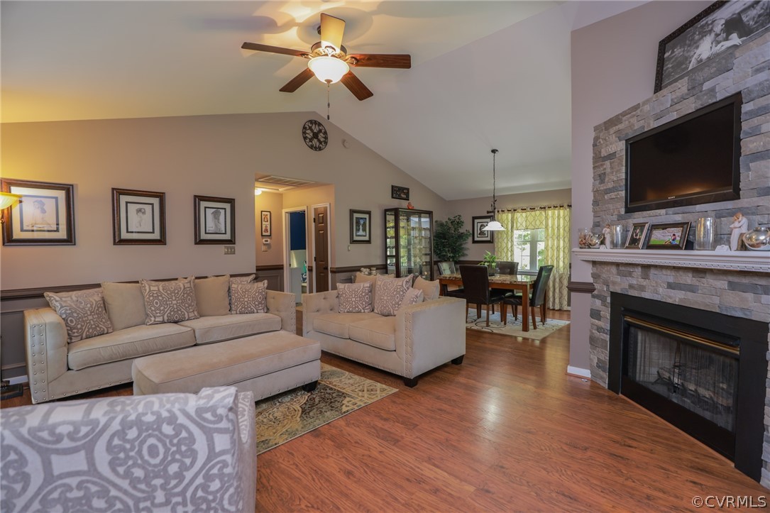 11706 Corte Castle Road Chesterfield, VA 23838 - Photo 10 of 44 a living room with couches a fireplace and a flat screen tv