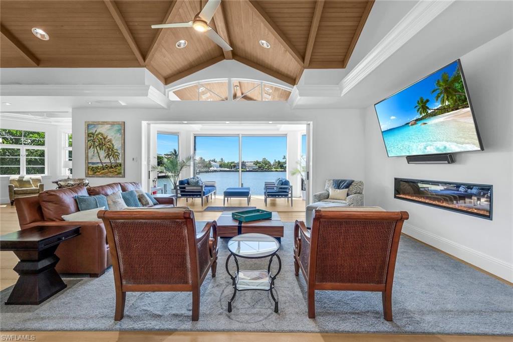 400 Springline Drive Naples, FL 34102 - Photo 13 of 37 Living room with healthy amount of natural light, high vaulted ceiling, a ceiling fan, recessed lighting, and a wooden ceiling with exposed beams