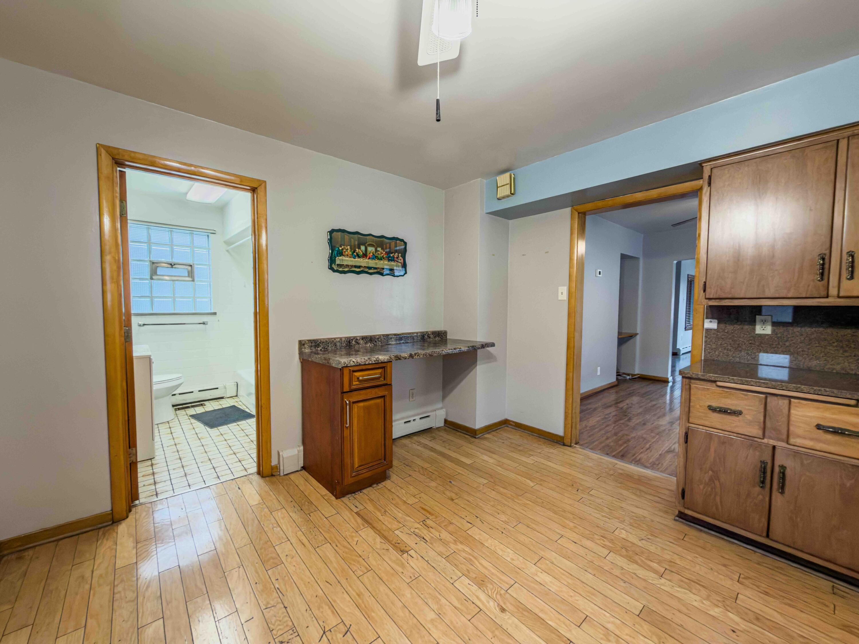 1218 120th Street Whiting, IN 46394 - Photo 8 of 25 a bedroom with a bed and a view of kitchen