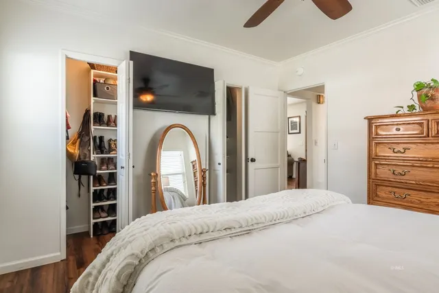 a bedroom with a bed and a flat screen tv