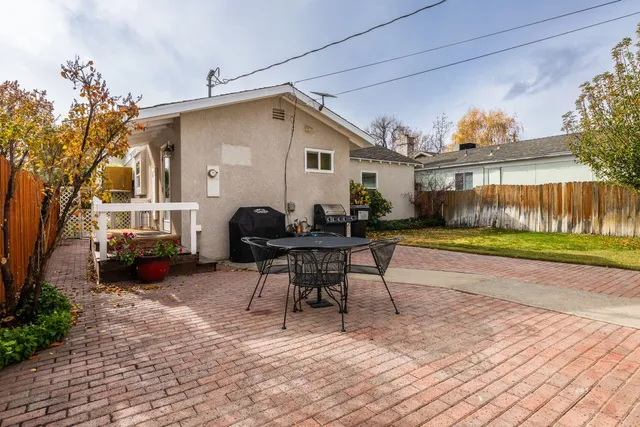 a view of a house with backyard and sitting area