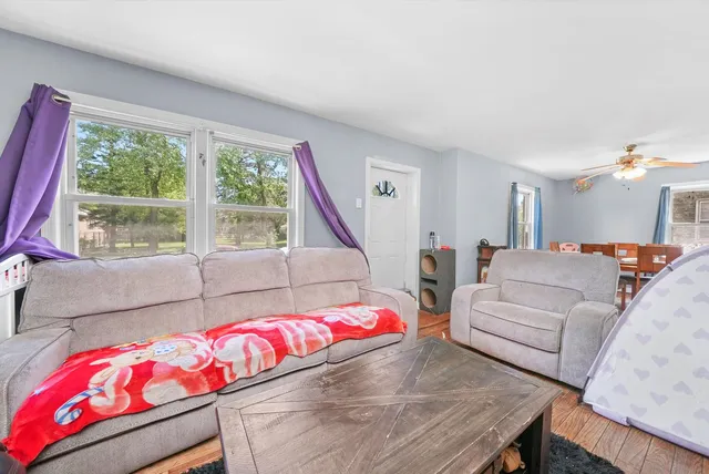 a bedroom with furniture and a large window