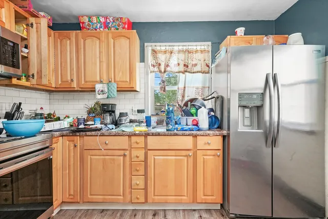 a kitchen with stainless steel appliances a refrigerator sink and cabinets