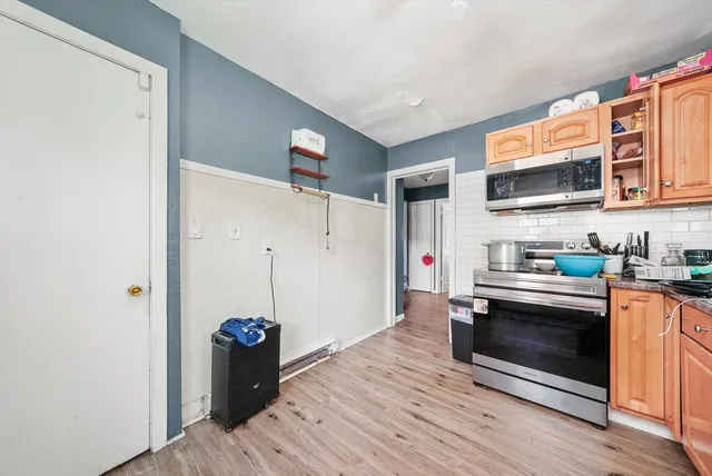 a kitchen with stainless steel appliances granite countertop a refrigerator and a stove top oven