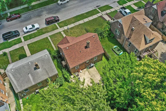 an aerial view of a house with a garden and trees