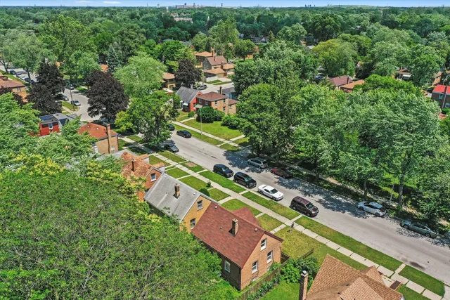 an aerial view of residential houses with outdoor space and street view