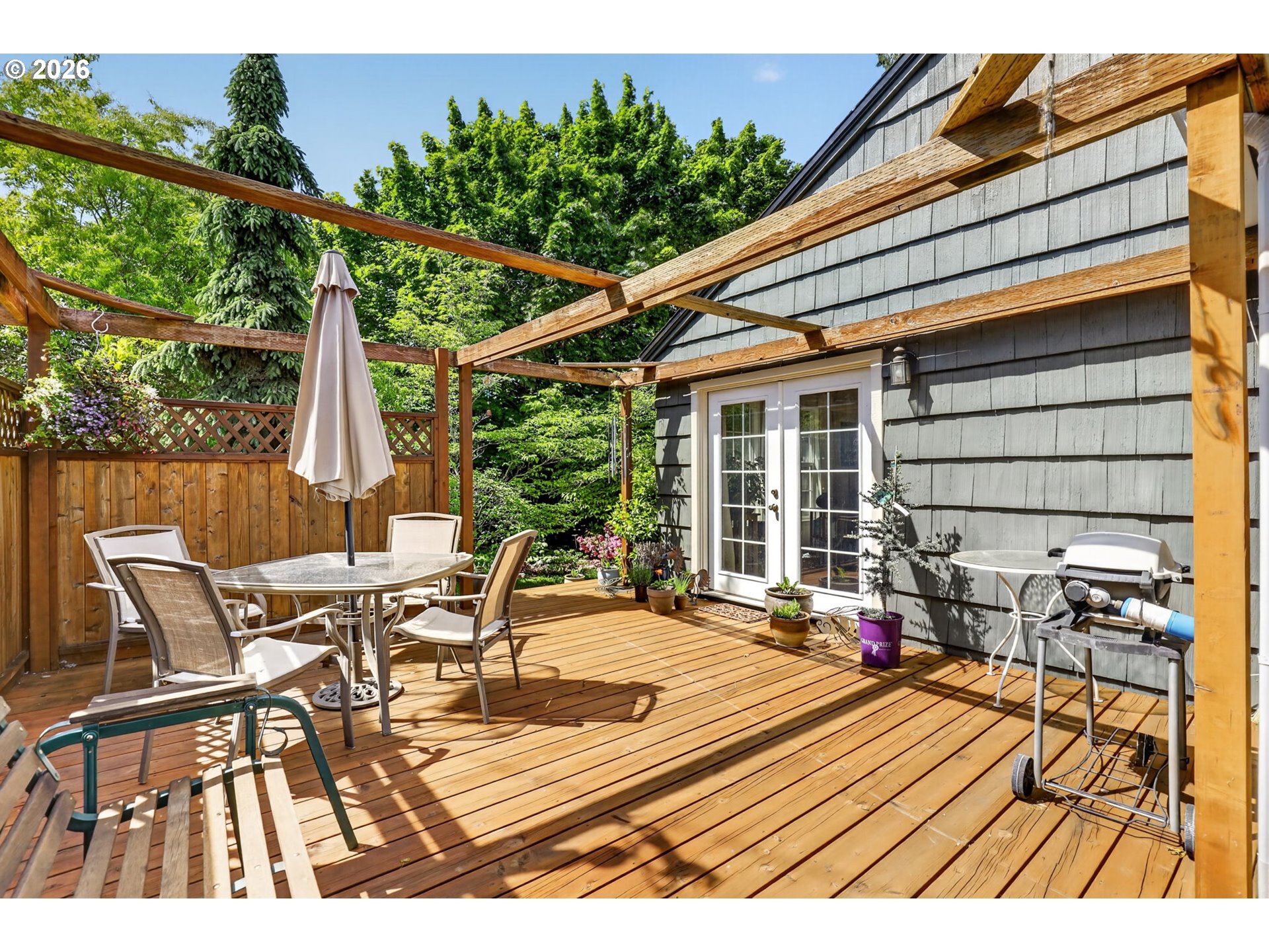 33951 Southeast Coupland Road Estacada, OR 97023 - Photo 31 of 48 a view of a patio with table and chairs with wooden floor and fence