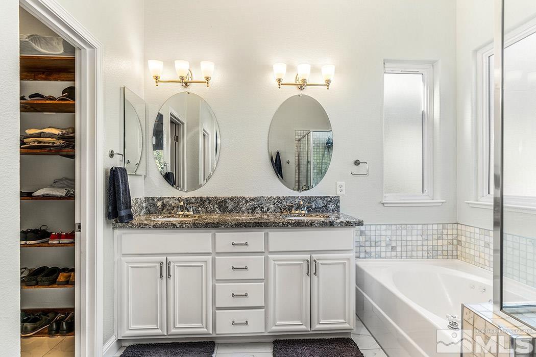 10589 Twin Bridges Way Reno, NV 89521 - Photo 17 of 34 a bathroom with a double vanity sink and a mirror