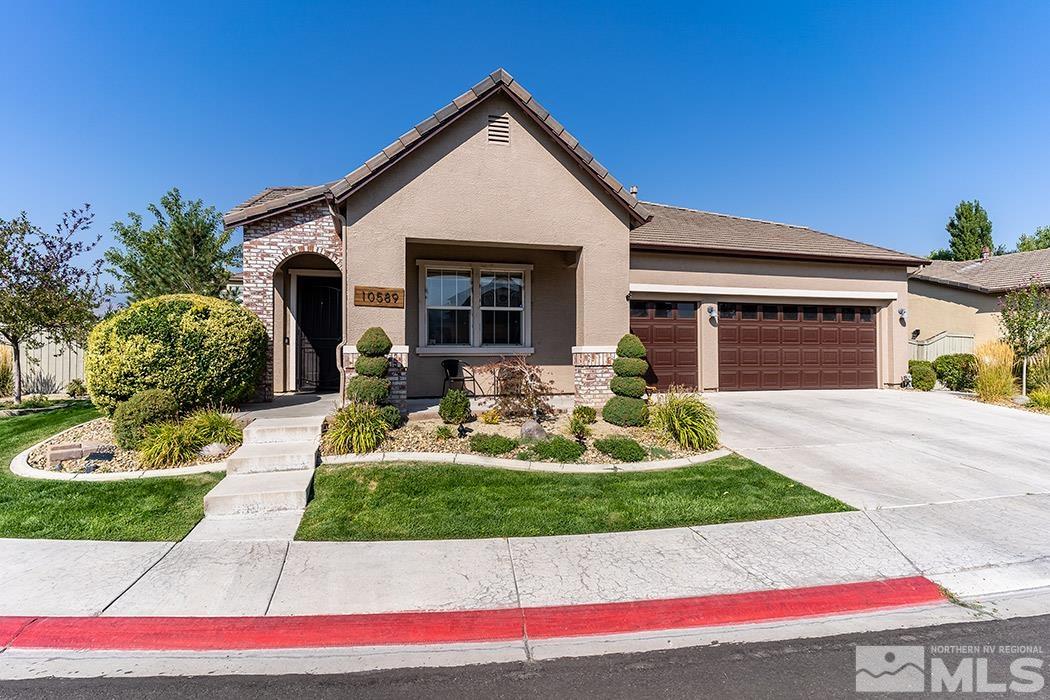 10589 Twin Bridges Way Reno, NV 89521 - Photo 2 of 34 a front view of a house with a yard