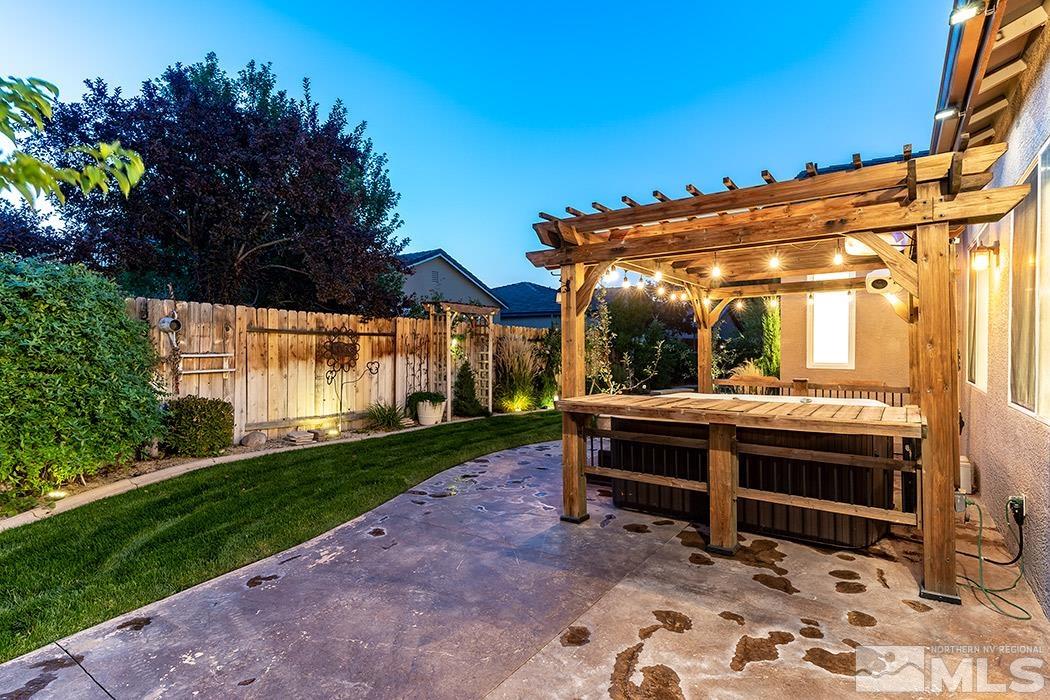 10589 Twin Bridges Way Reno, NV 89521 - Photo 22 of 34 a view of backyard with a table and chairs under an umbrella