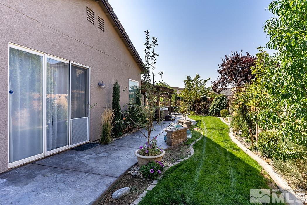 10589 Twin Bridges Way Reno, NV 89521 - Photo 34 of 34 a view of a backyard with plants and a patio