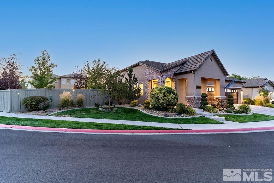 10589 Twin Bridges Way Reno, NV 89521 - Photo 4 of 34 a front view of a house with a yard and garage
