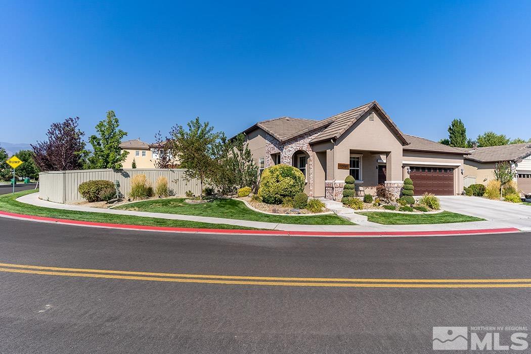 10589 Twin Bridges Way Reno, NV 89521 - Photo 5 of 34 a front view of a house with a yard and potted plants