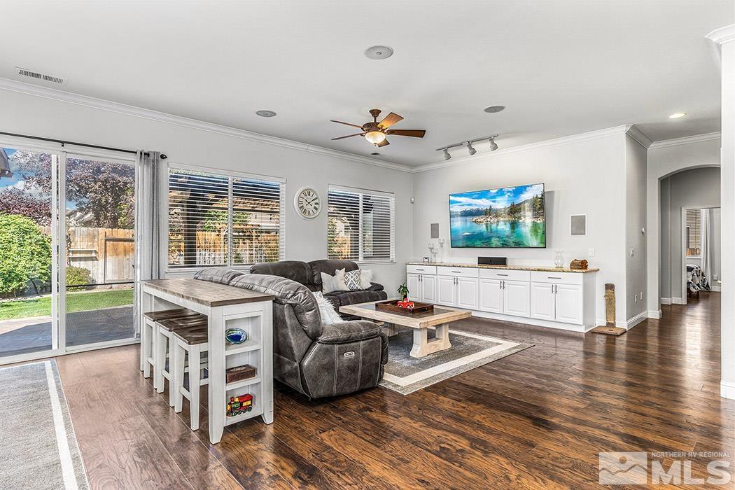 10589 Twin Bridges Way Reno, NV 89521 - Photo 10 of 34 a living room with furniture a flat screen tv and a large window