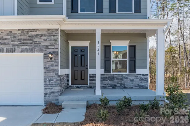 a view of front door of a house with potted plants