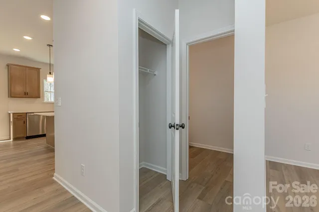 a view of a hallway with wooden floor