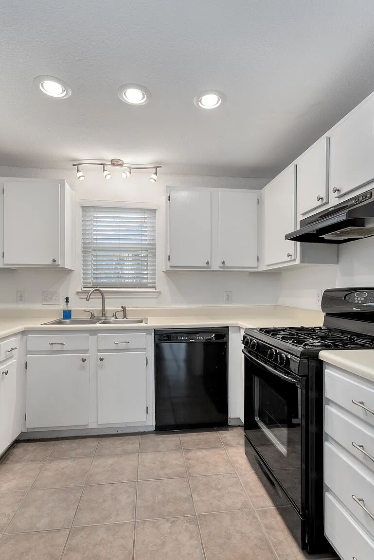 11970 Jollyville Road, Unit 202 Austin, TX 78759 - Photo 8 of 25 A well-lit kitchen with modern appliances and ample cabinet storage.