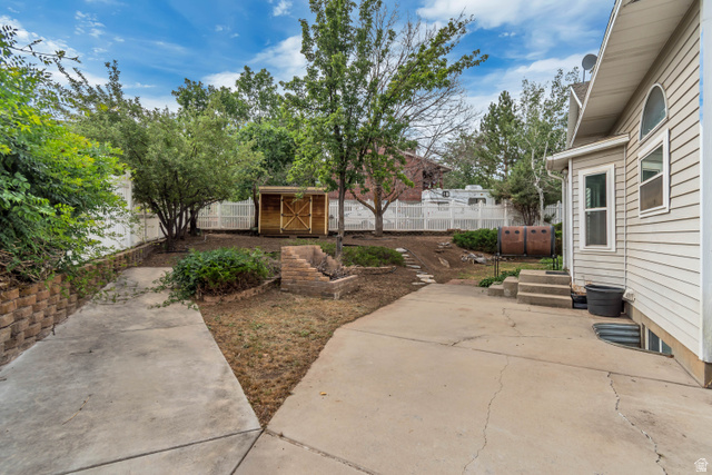 332 East Magellan Lane Elk Ridge, UT 84651 - Photo 23 of 24 Expansive concrete patio area with multi-level landscaping