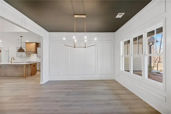 a view of an empty room with a window and fireplace