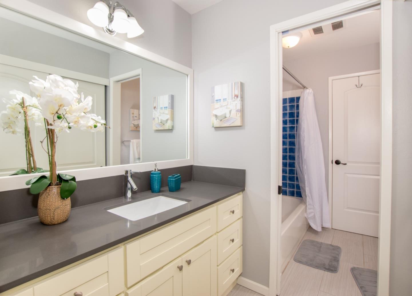 101 Redding Road, Unit C6 Campbell, CA 95008 - Photo 11 of 17 a bathroom with a granite countertop sink a toilet a mirror and shower
