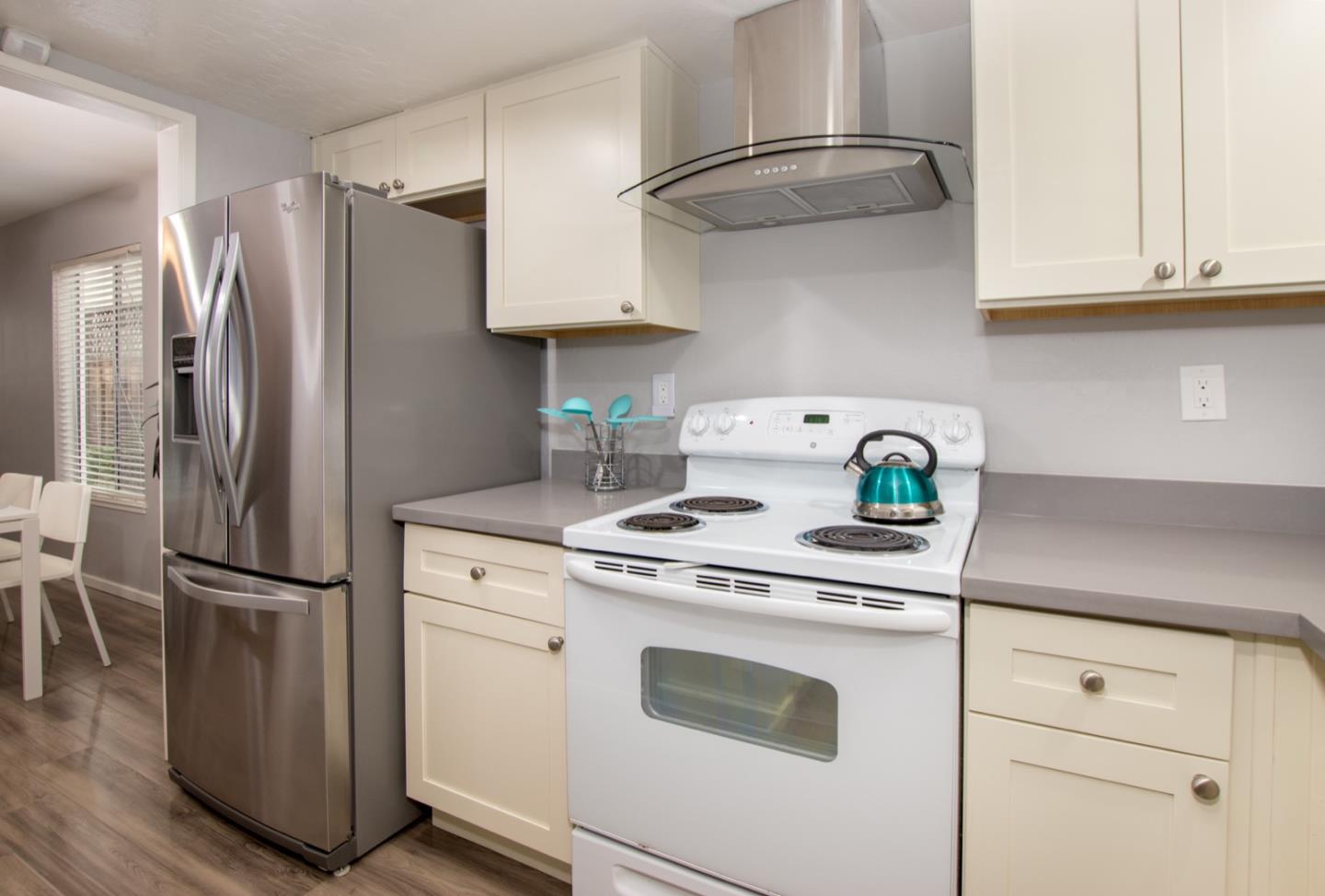 101 Redding Road, Unit C6 Campbell, CA 95008 - Photo 4 of 17 a kitchen with stainless steel appliances white cabinets and a refrigerator