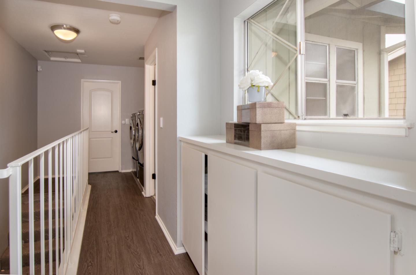 101 Redding Road, Unit C6 Campbell, CA 95008 - Photo 9 of 17 a hallway with white cabinets and wooden floor