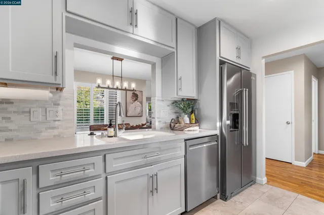 a spacious bedroom with a bed and a lamp