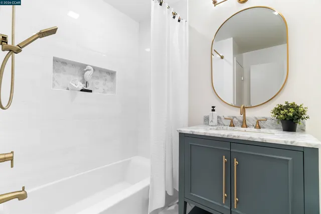 a kitchen with granite countertop white cabinets and appliances