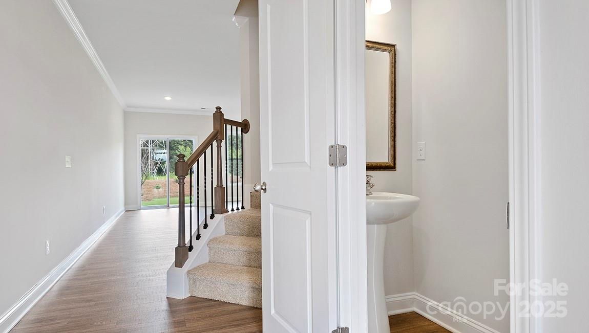 385 Lagoon Road Fletcher, NC 28732 - Photo 12 of 30 a view of a hallway with wooden floor and staircase