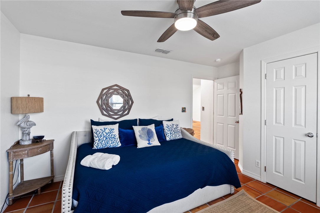 21 Flamingo Road Rockport, TX 78382 - Photo 12 of 30 a bedroom with a bed and a table in it