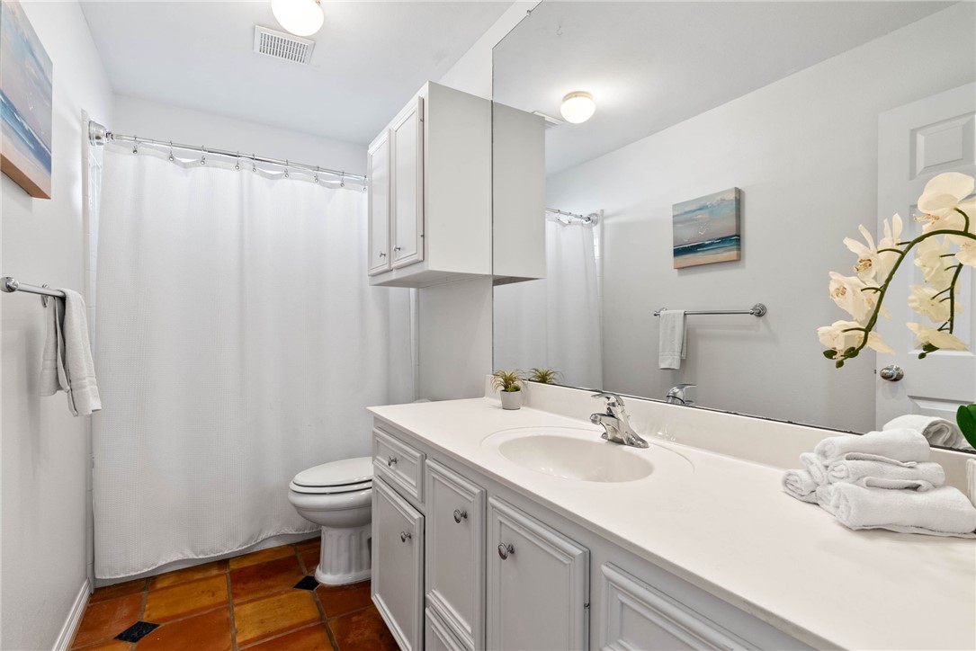 21 Flamingo Road Rockport, TX 78382 - Photo 14 of 30 a bathroom with a sink toilet double vanity and tub