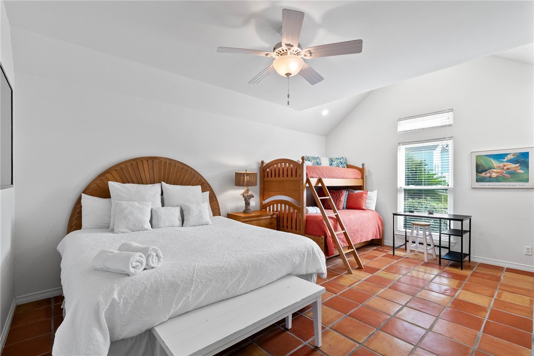 21 Flamingo Road Rockport, TX 78382 - Photo 15 of 30 a bedroom with two beds and a chandelier